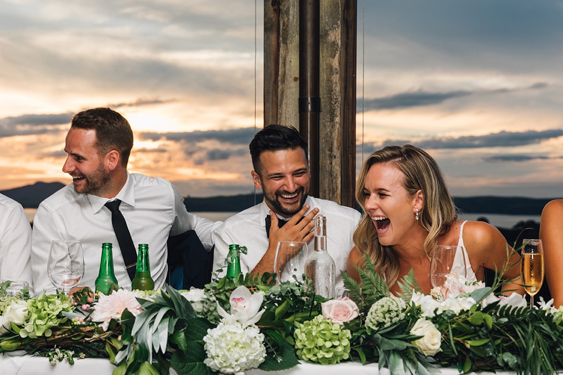 Newlyweds laughing together at their wedding reception